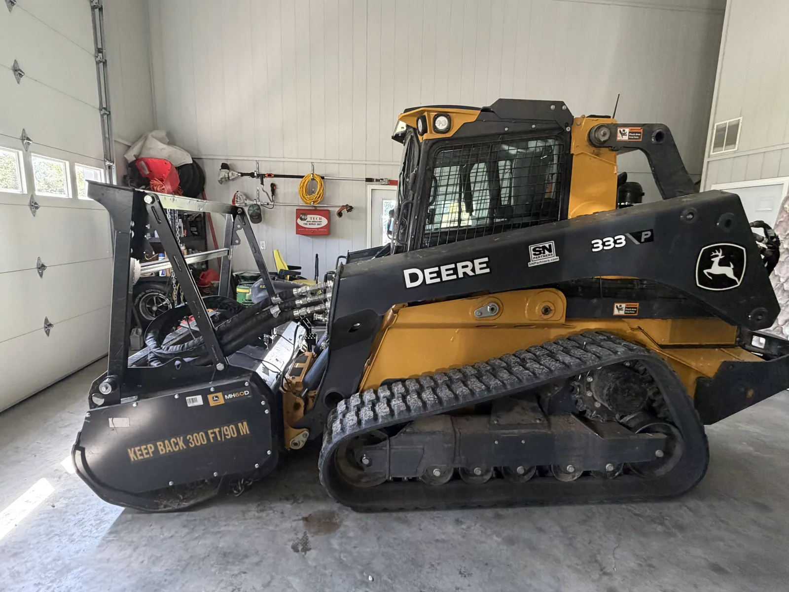 Compact track loader fitted with a forestry mulching head
