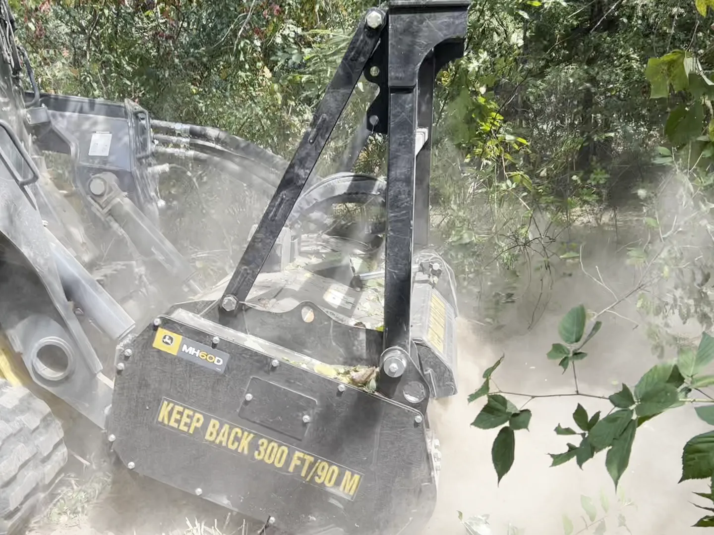 Close view of the MH60D mulching head grinding brush in a cloud of dust