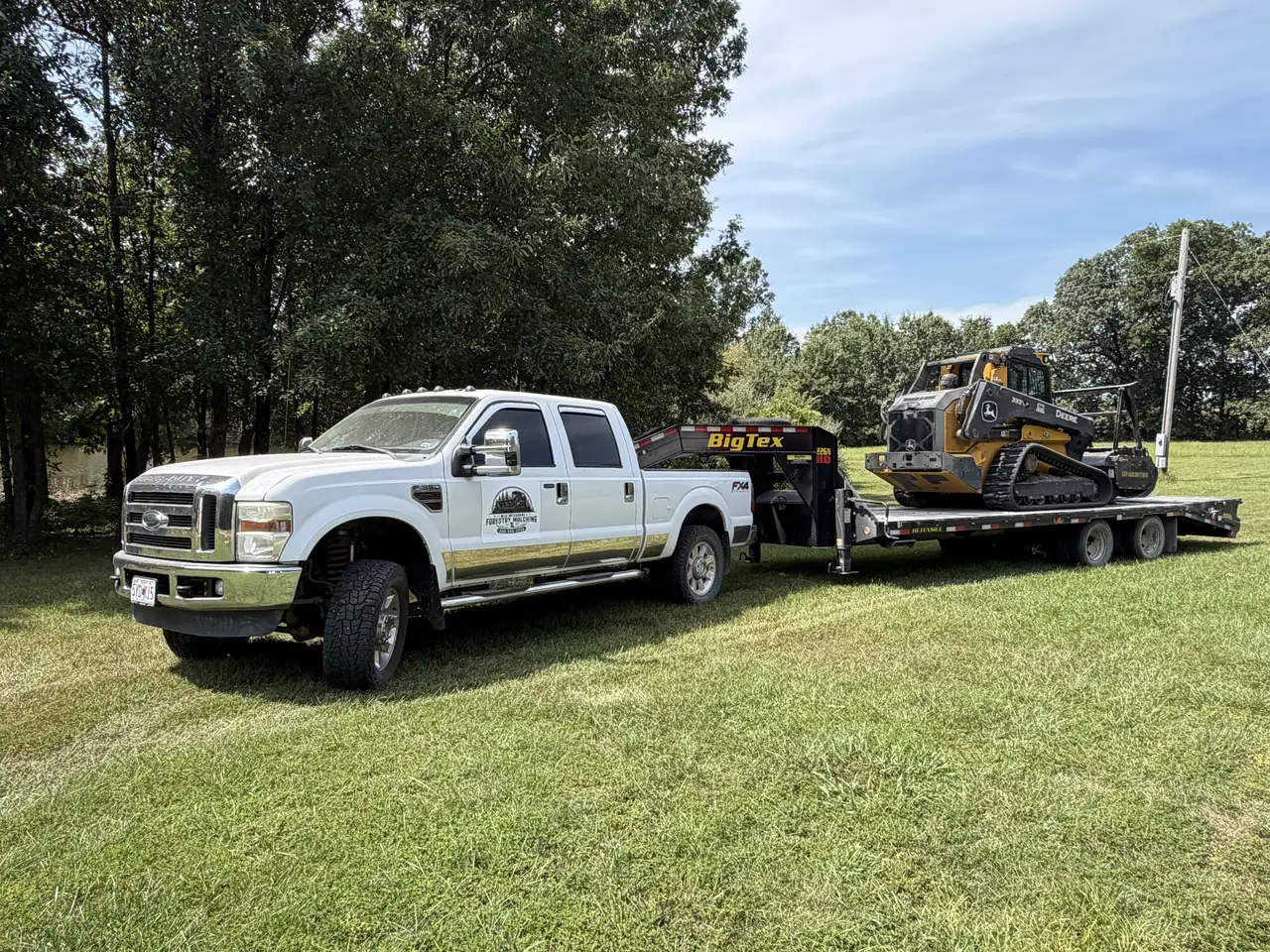 Mid Missouri Forestry Mulching truck and trailer with the Deere 333P mulcher loaded