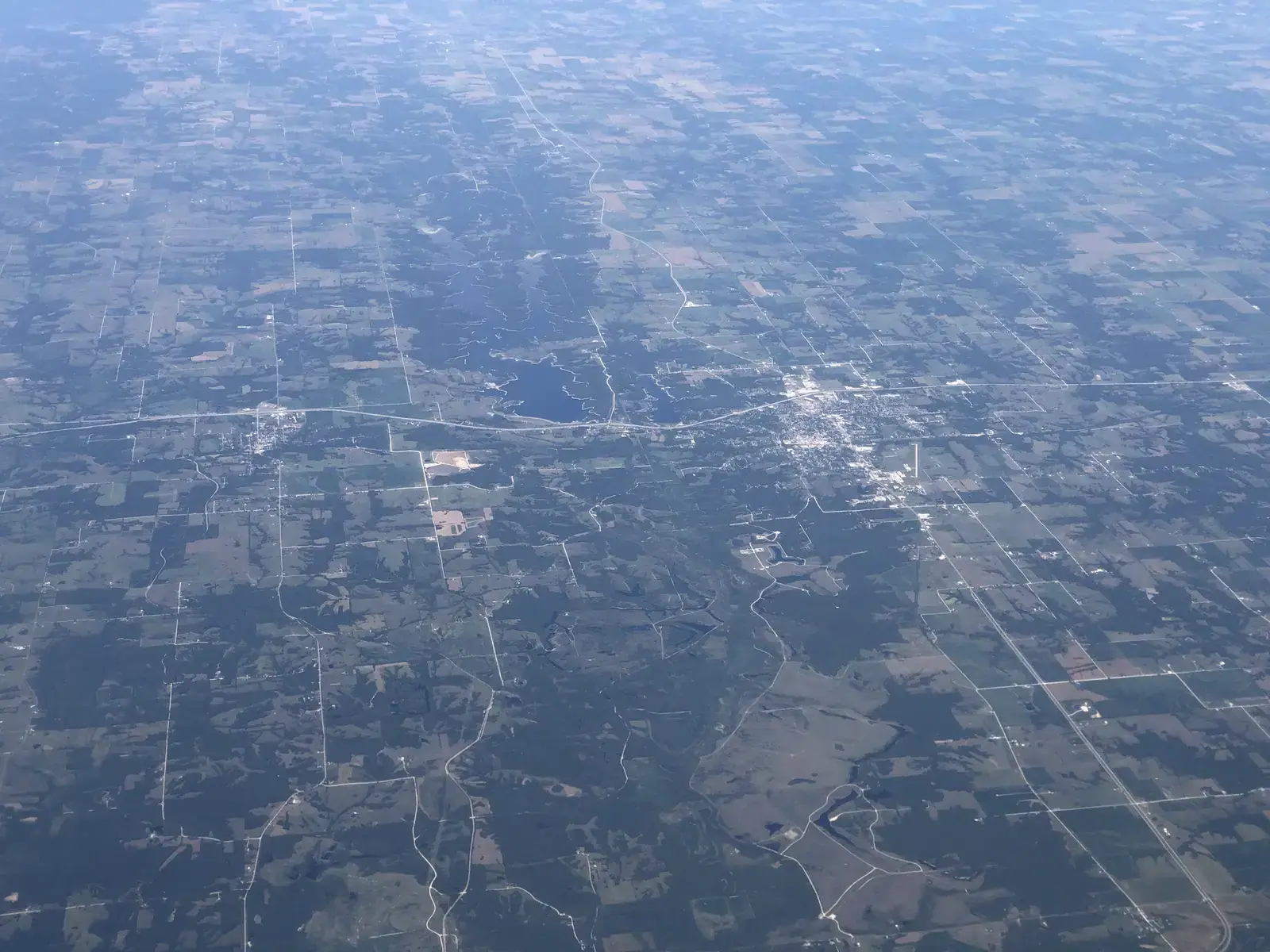 Aerial view of farm ground and timber around Macon, Missouri