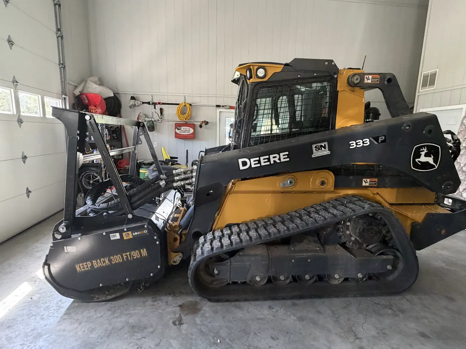 Compact track loader fitted with a forestry mulching head